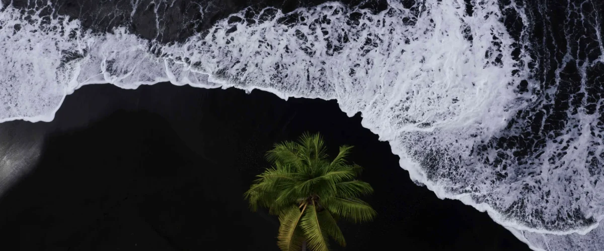 Black sand beach in The Islands of Tahiti © Jim Winter